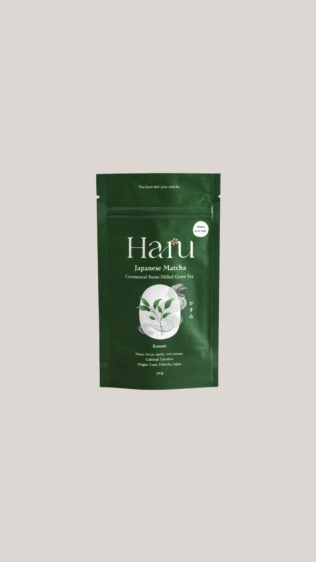 A dark green stand-up pouch of Haru Japanese  Kasumi Matcha tea, featuring a white logo and a graphic of green tea leaves in a cup, centered on a light gray background.