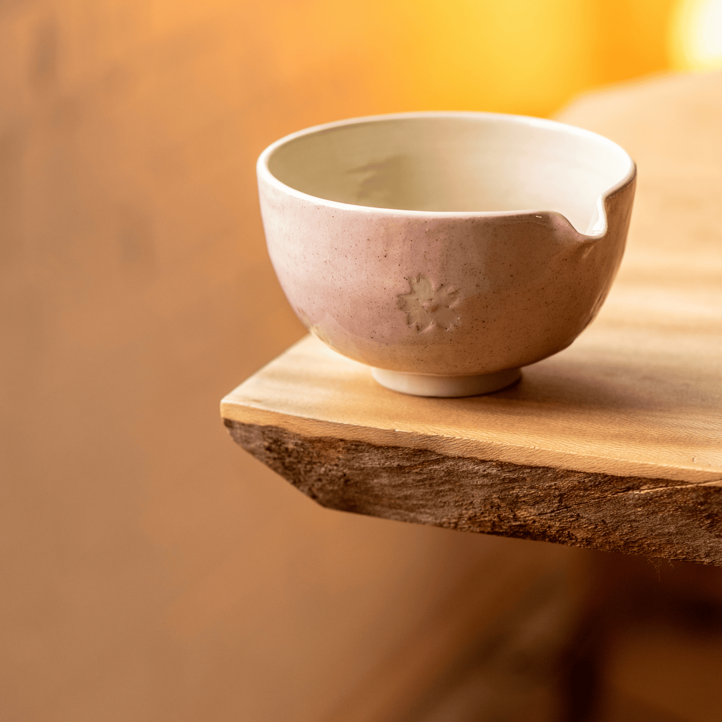 Ceramic bowl on a wooden surface with a warm background