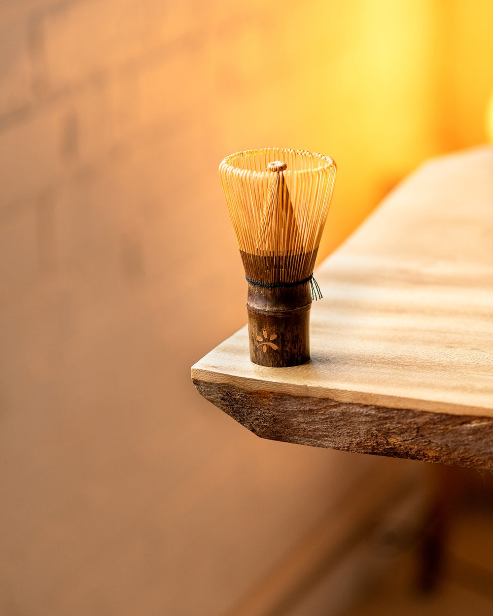 Matcha Whisk upright on table with sakura logo